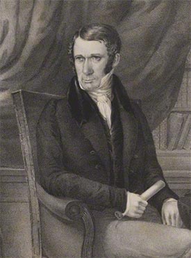Print portrait of George Faithfull, posed seated, wearing a high collar, dark jacket and holding a paper scroll